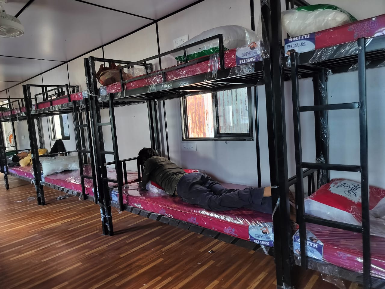 Portable bunk house interior with steel bunk beds